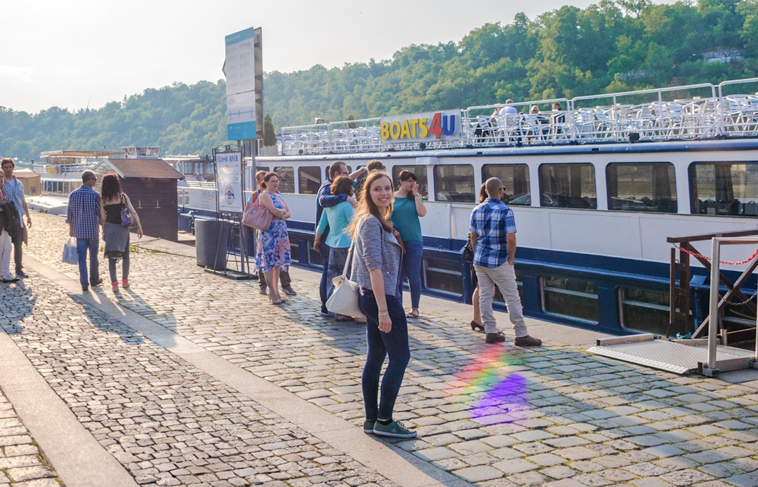 Tourists boarding a boat for a 1-hour panoramic cruise on the Vltava River.