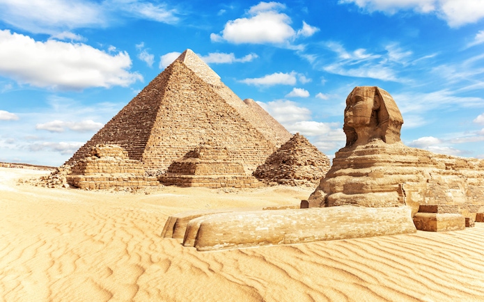 Giza Pyramids and Sphinx under blue sky on a half-day guided tour.