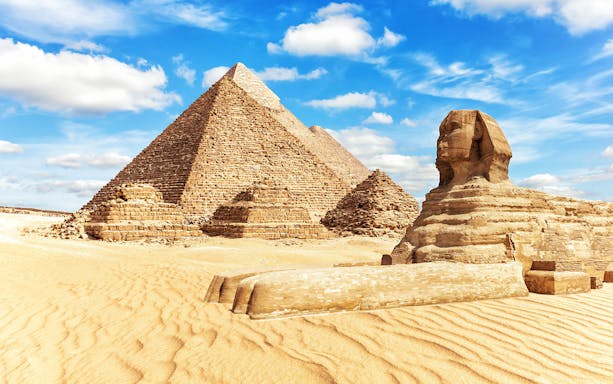 Giza Pyramids and Sphinx under blue sky on a half-day guided tour.