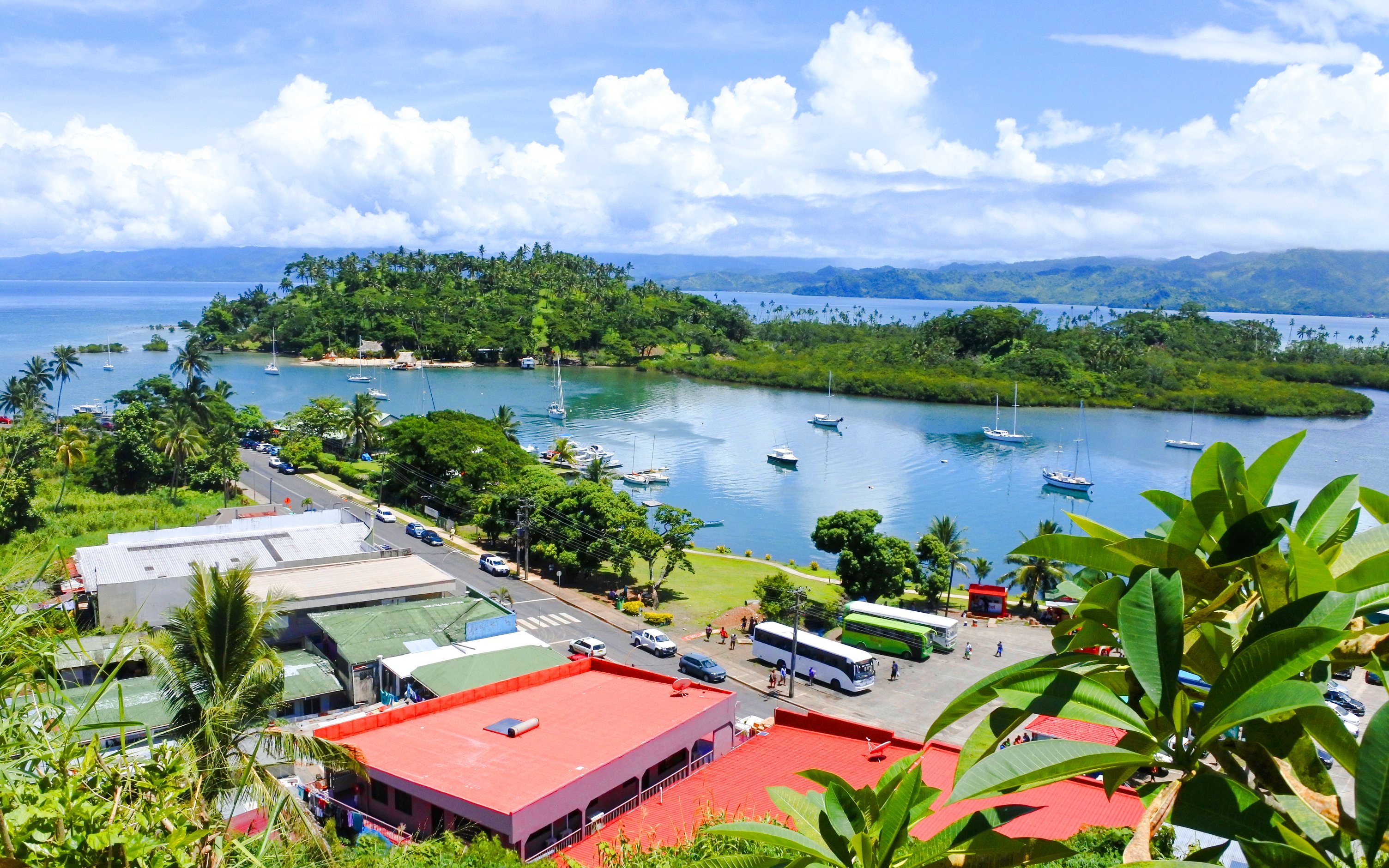 Aerial view of Savusavu harbor with boats and lush greenery, Vanua Levu, Fiji.
