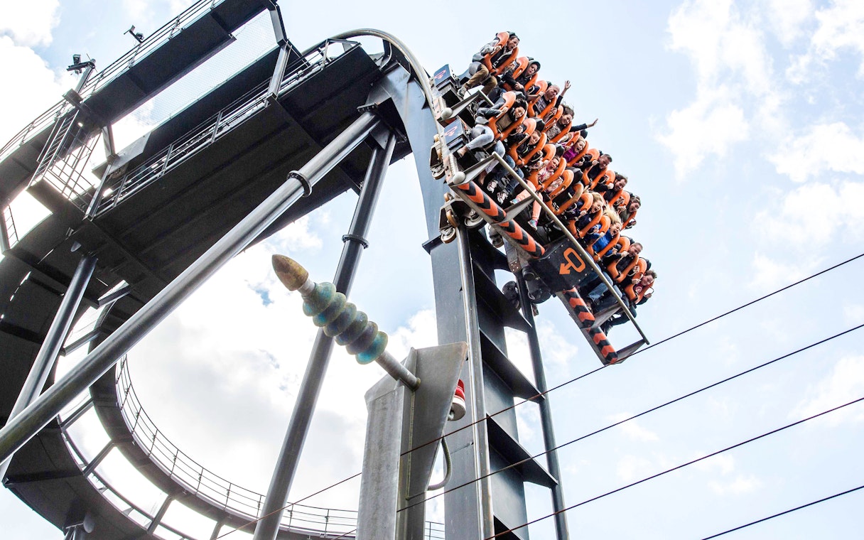 Guests on the Oblivion roller coaster at Alton Towers, descending a steep drop.