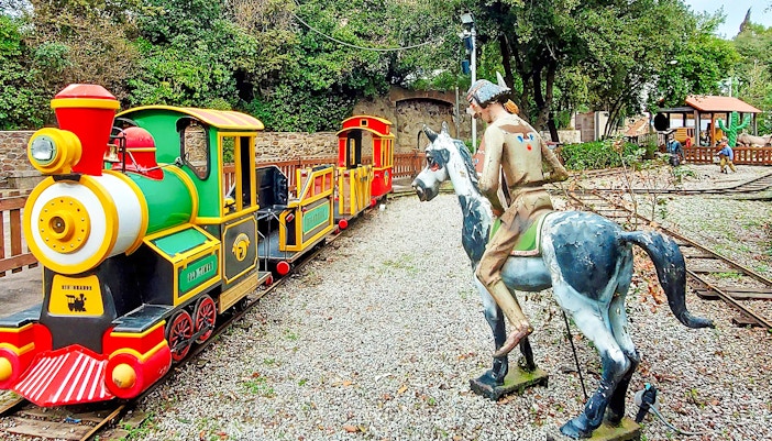 Miniature train and cowboy statue at Rio Grande, Tibidabo Amusement Park.