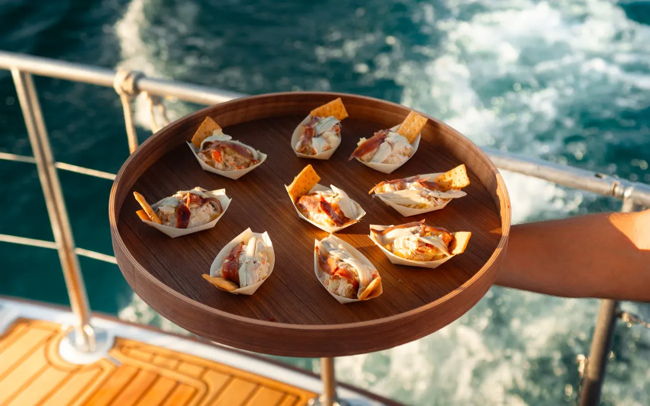 Mediterranean tasting menu on a tray aboard Salacia during Benalmádena sunset cruise.