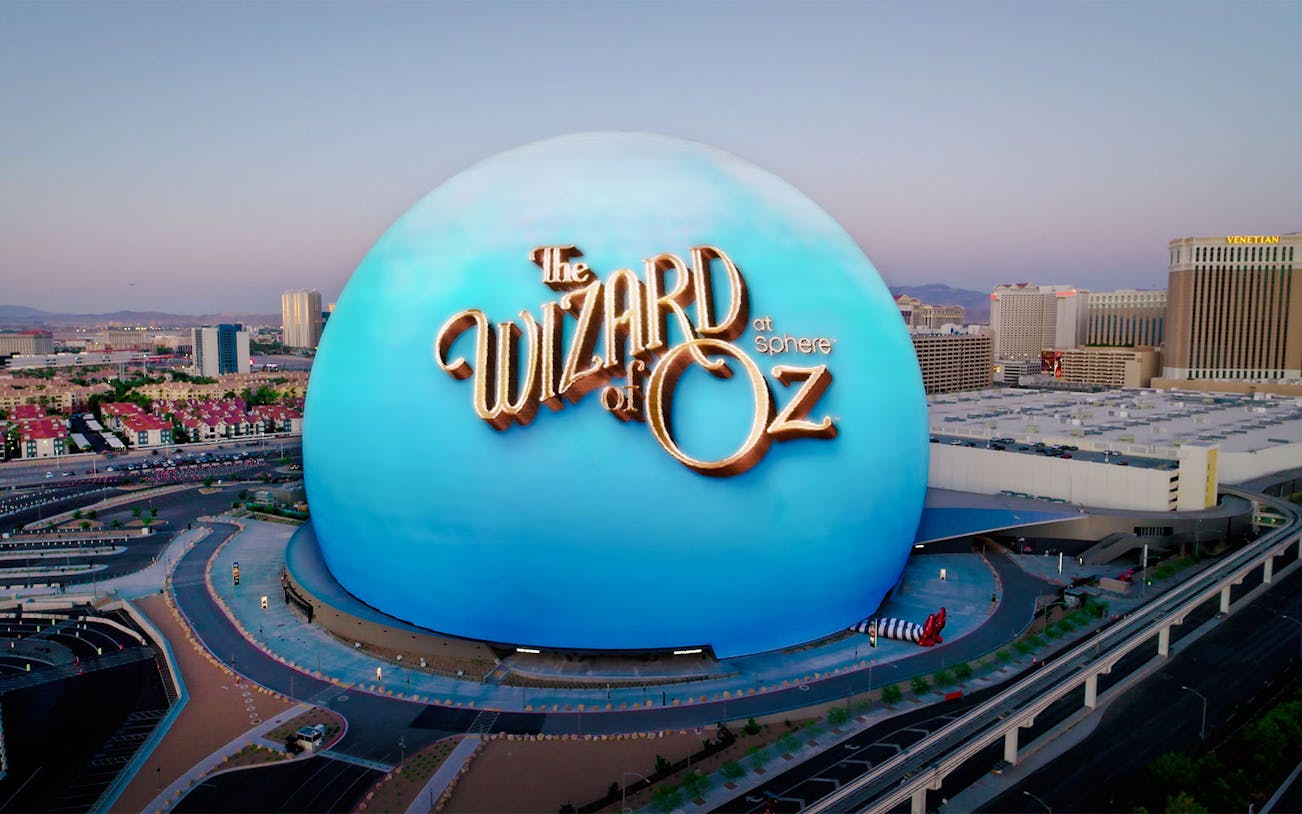 Wizard of Oz performance at Sphere, featuring vibrant stage set and cast in colorful costumes.