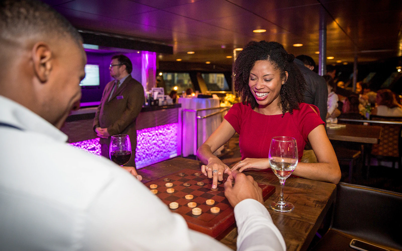 Woman playing Connect 4 on a New York dinner cruise.