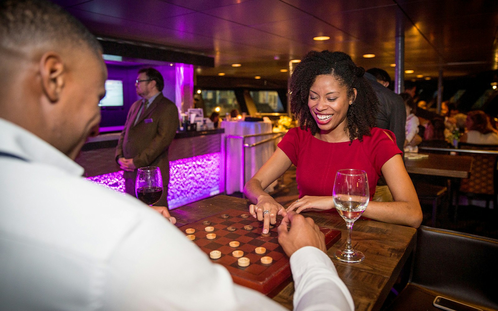 Woman playing Connect 4 on a New York dinner cruise.