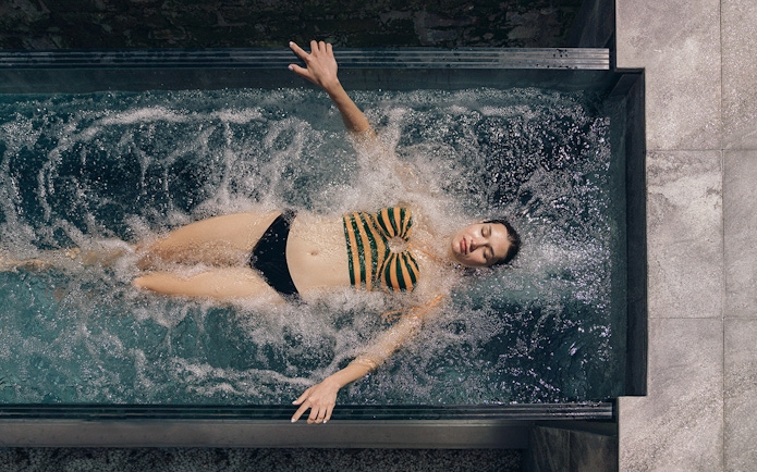 Person relaxing in a spa pool at QC Terme Milano, Italy.