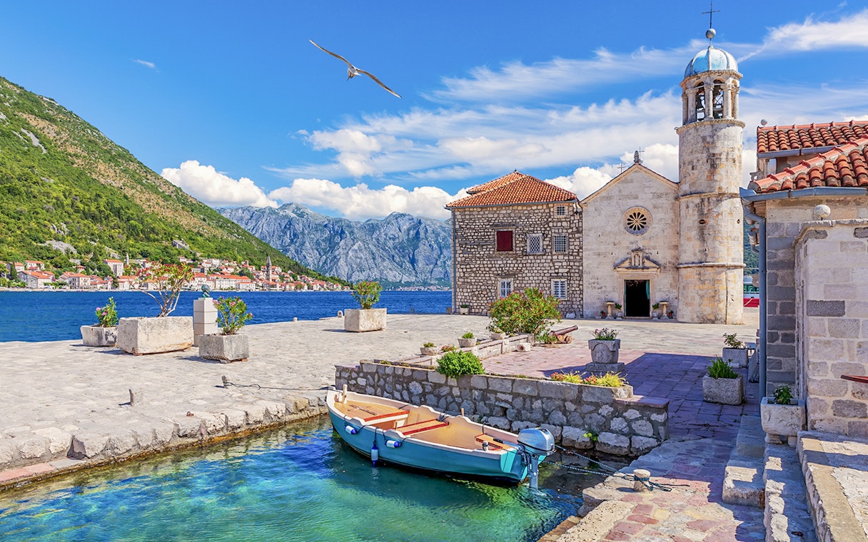 Church of Our Lady of the Rocks with boat in Bay of Kotor, Montenegro.