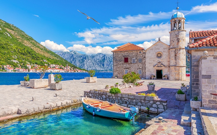 Church of Our Lady of the Rocks with boat in Bay of Kotor, Montenegro.