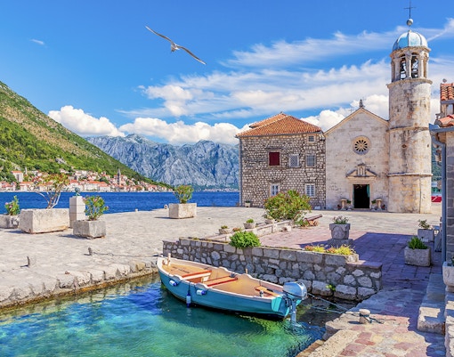Church of Our Lady of the Rocks with boat in Bay of Kotor, Montenegro.