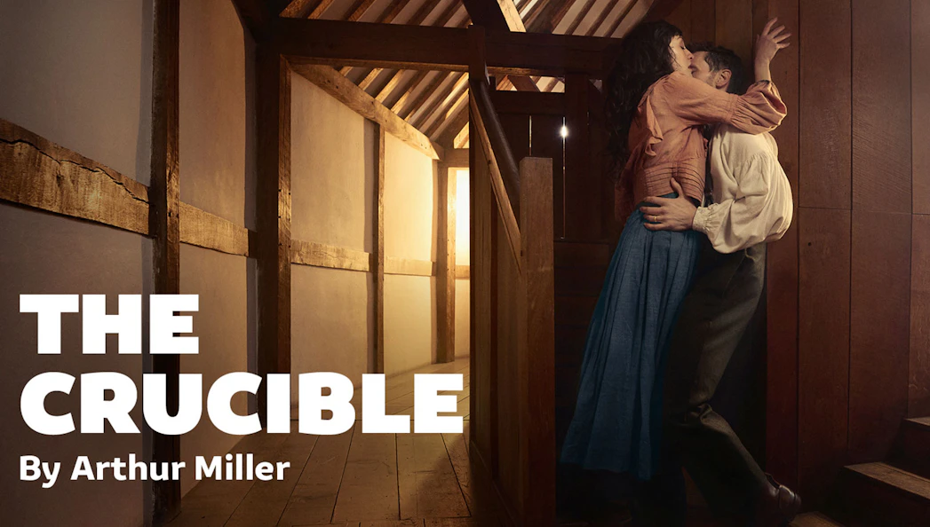 Couple embracing in a wooden interior, promoting Arthur Miller's play "The Crucible.