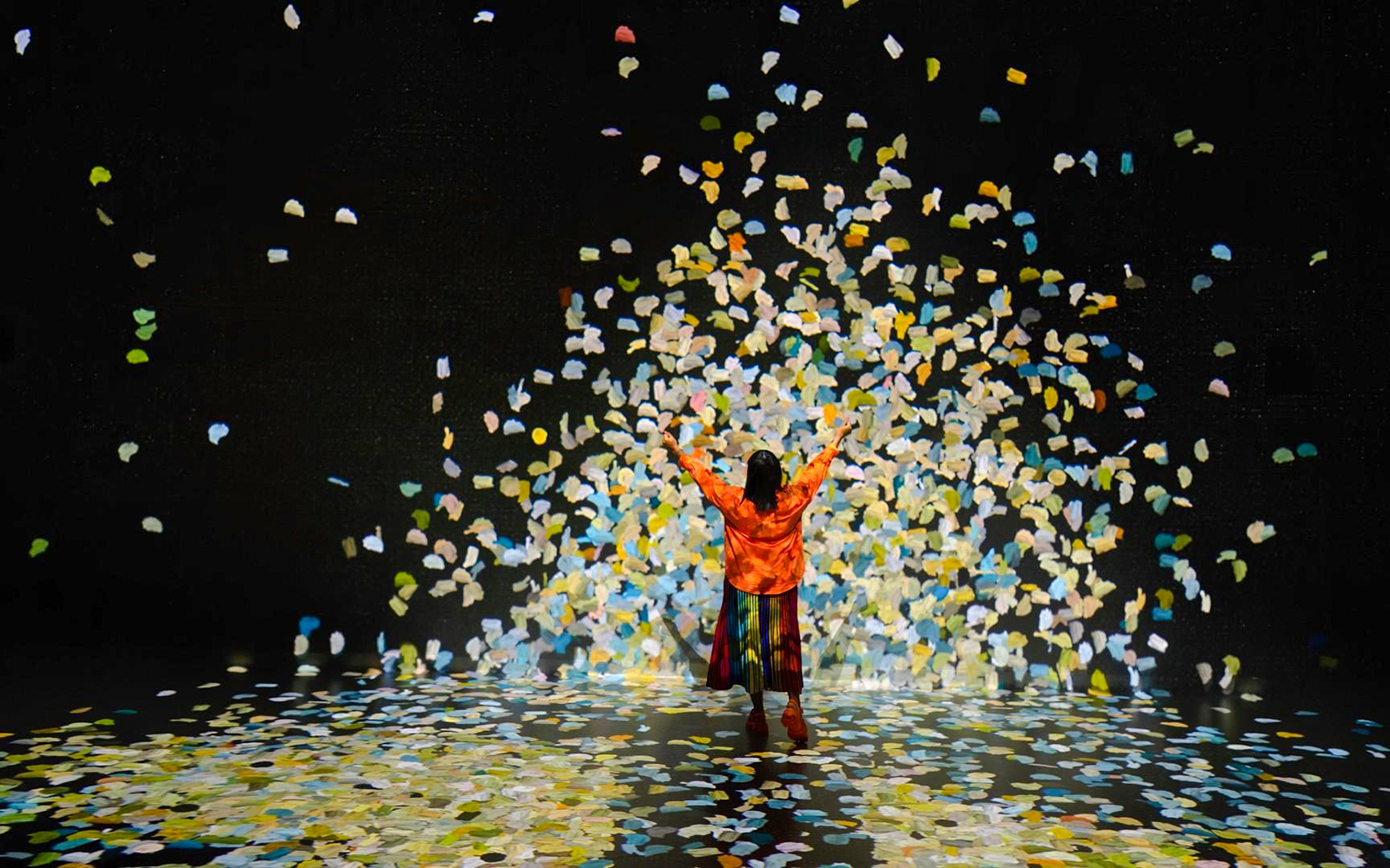 Guest surrounded by colorful confetti at Colour in Motion gallery, Frameless London.