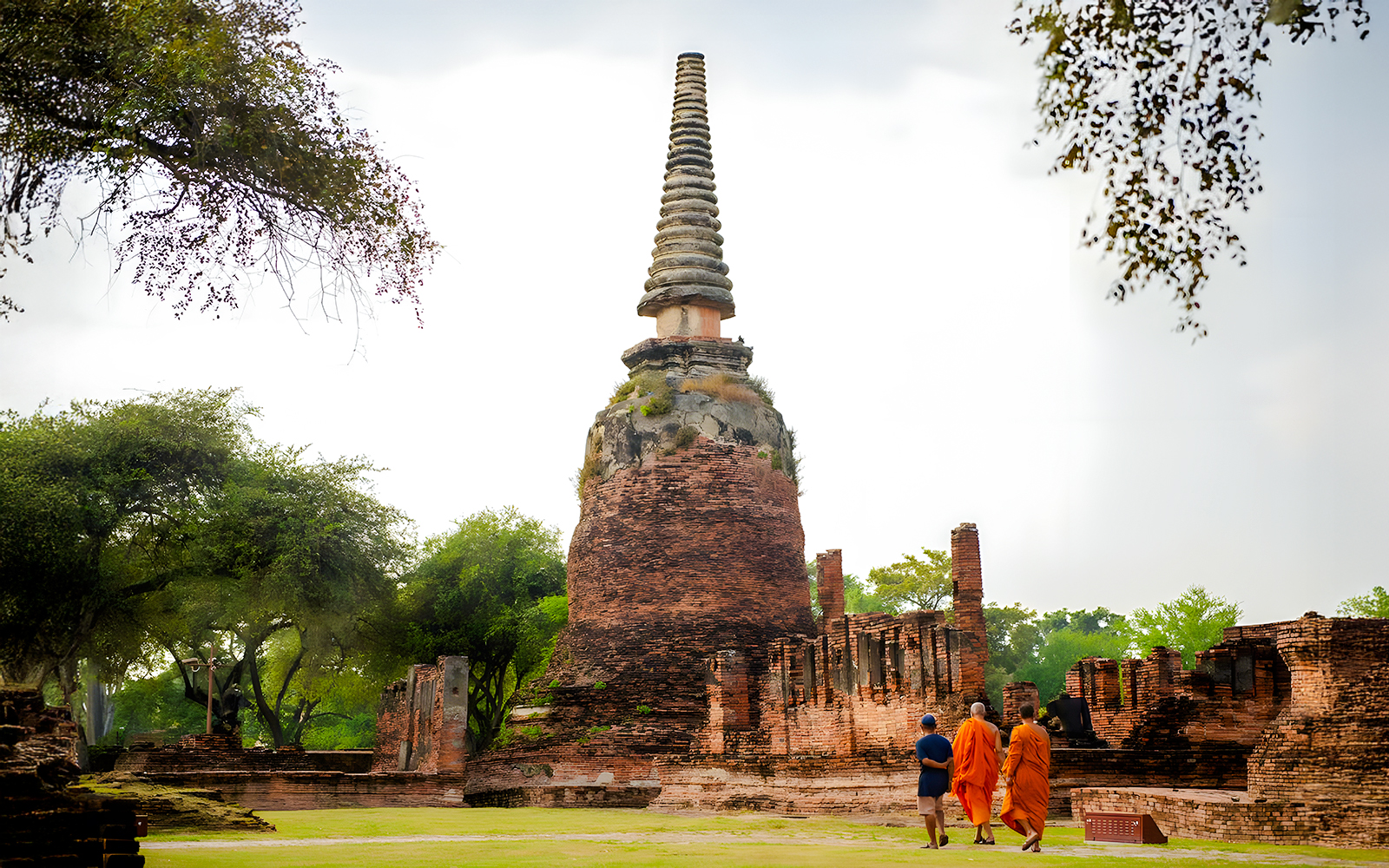 Monks walking near ancient ruins at Wat Phra Si Sanphet, Ayutthaya.