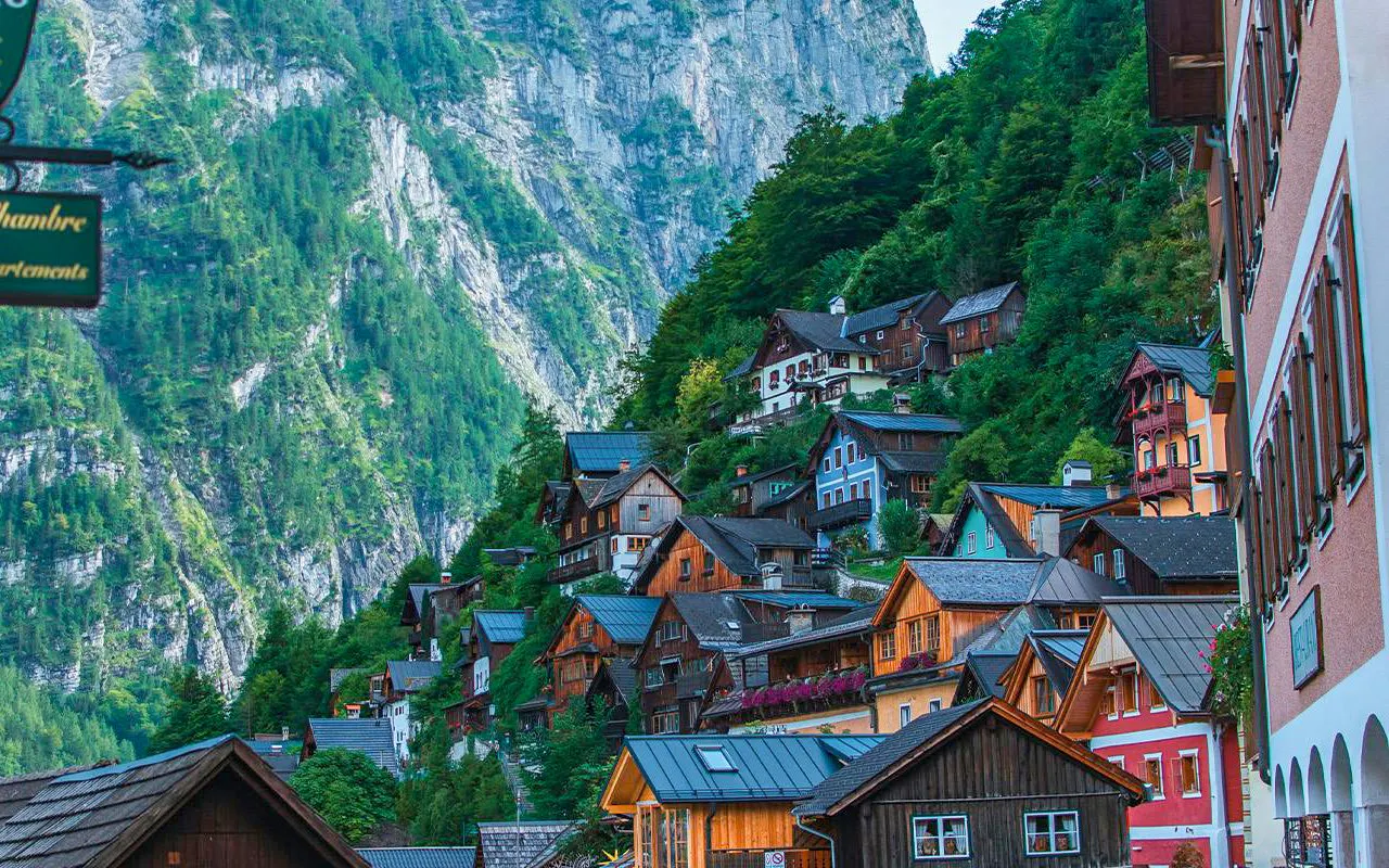 Colorful hillside houses in Hallstatt, Austria, with mountain backdrop on a day trip from Vienna.
