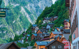 Colorful hillside houses in Hallstatt, Austria, with mountain backdrop on a day trip from Vienna.