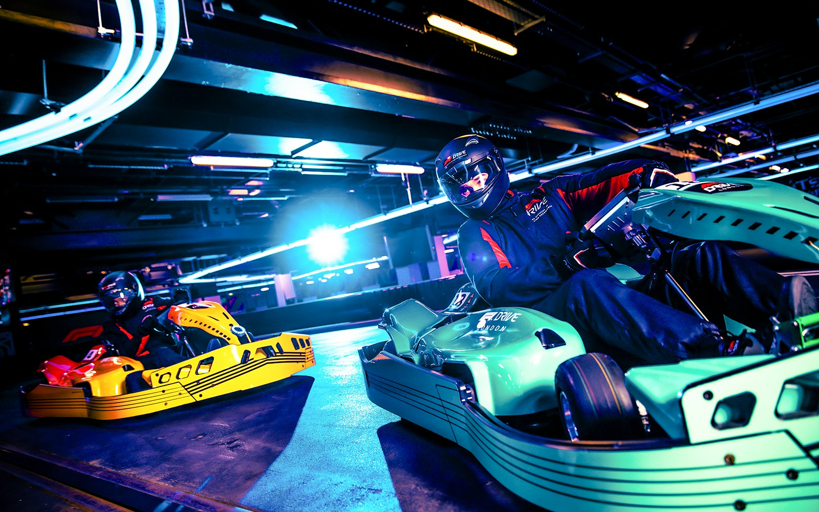 Guests driving go-karts at Elite F1 Drive session in London.