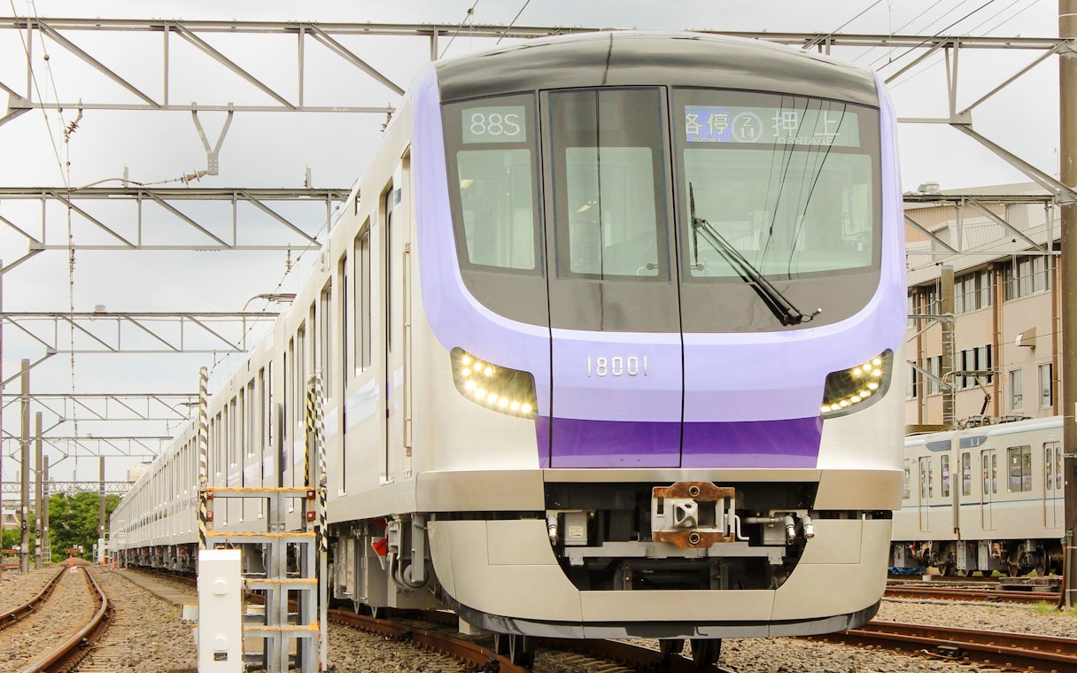 Tokyo Metro train on tracks, offering 24-hour unlimited rides with Toei Subway pass.