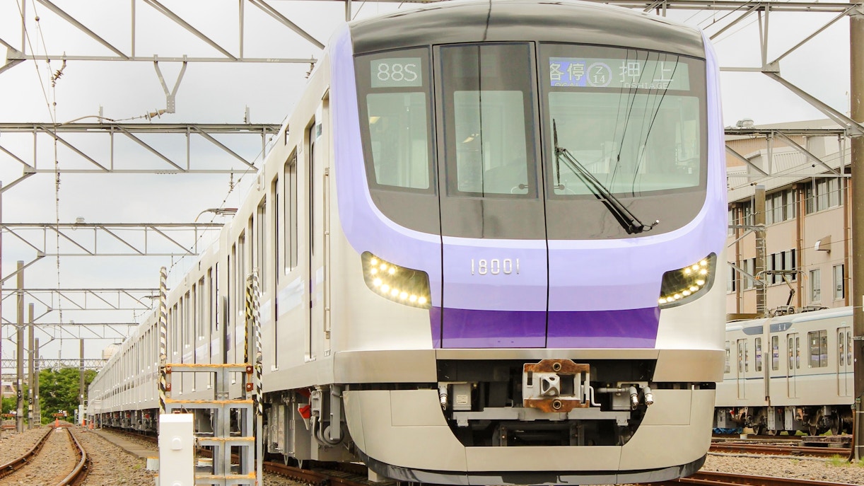 Tokyo Metro train on tracks, offering 24-hour unlimited rides with Toei Subway pass.
