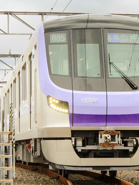 Tokyo Metro train on tracks, offering 24-hour unlimited rides with Toei Subway pass.