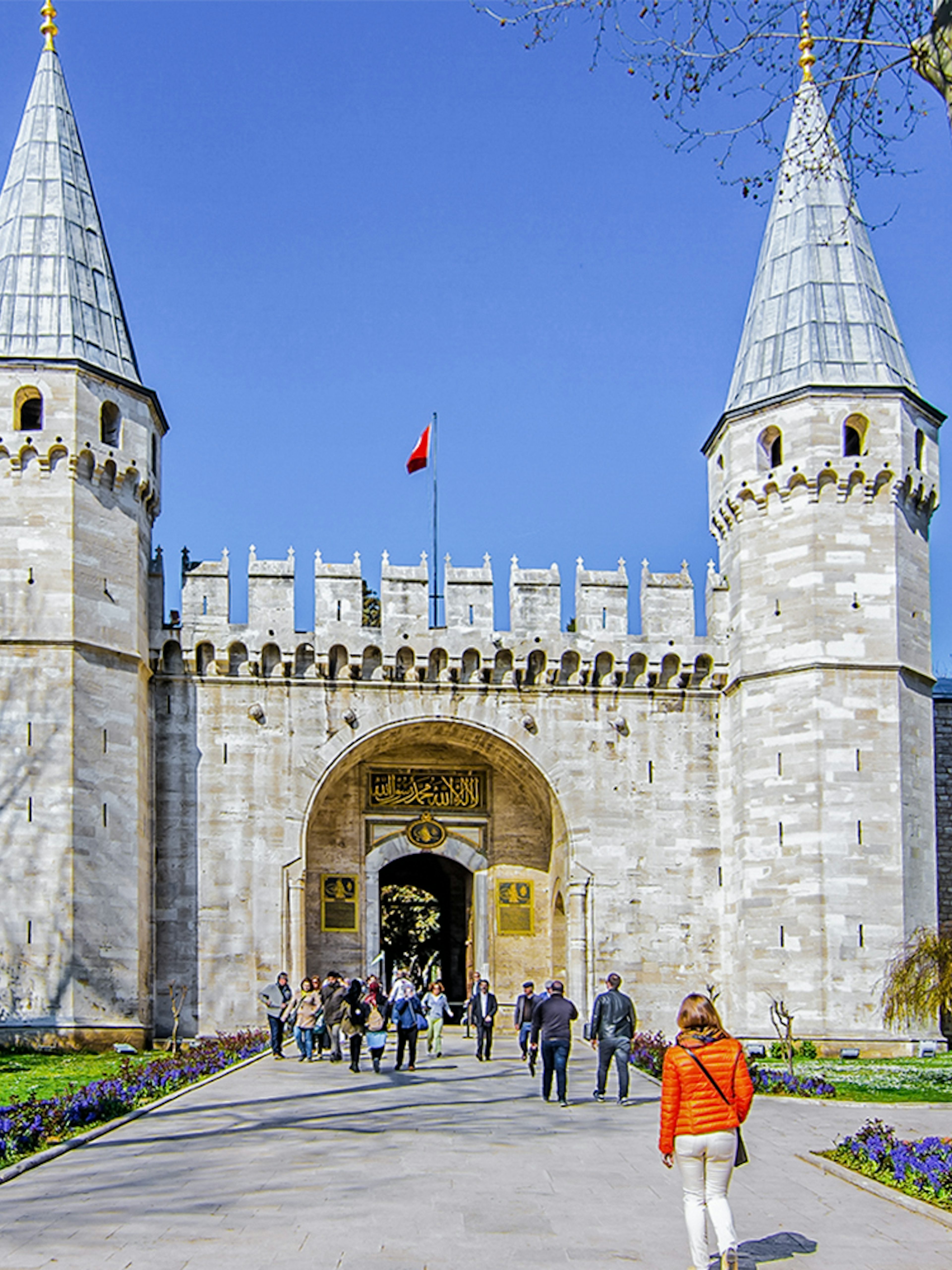 Gate of Salutation at Topkapi Palace, Istanbul, with visitors walking through.