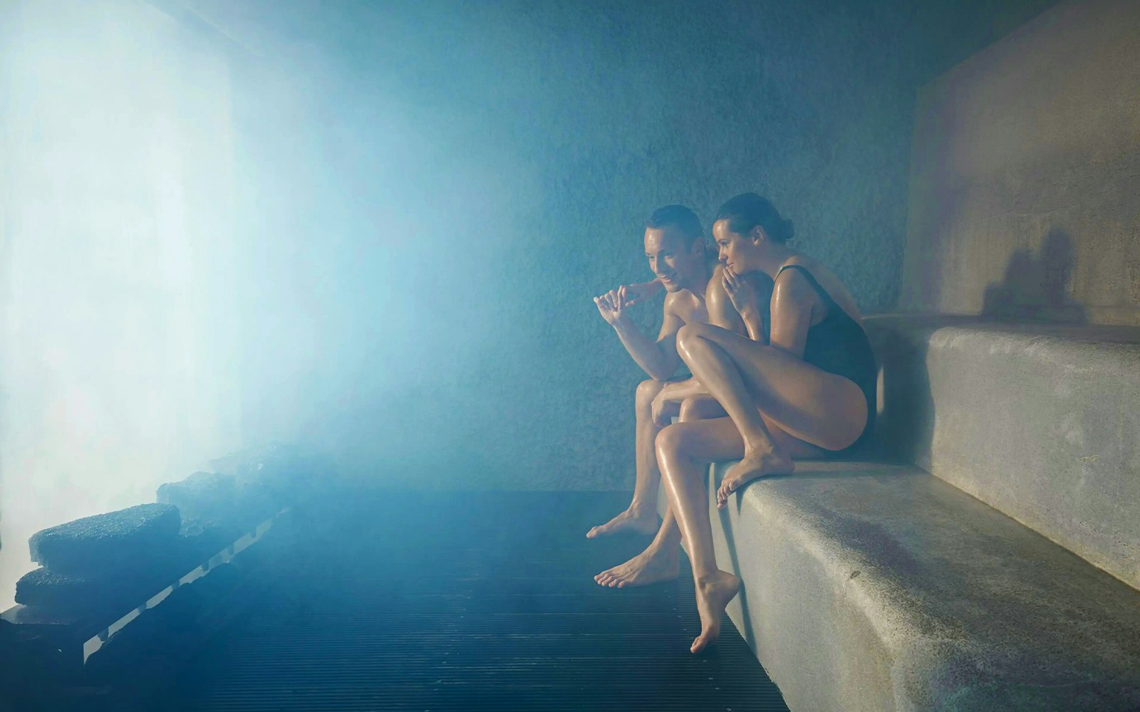 Two people relaxing in a steam room at Blue Lagoon, Iceland.