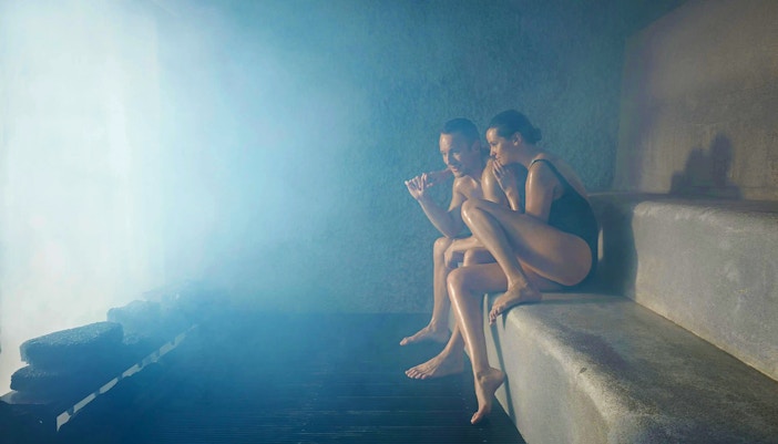 Two people relaxing in a steam room at Blue Lagoon, Iceland.