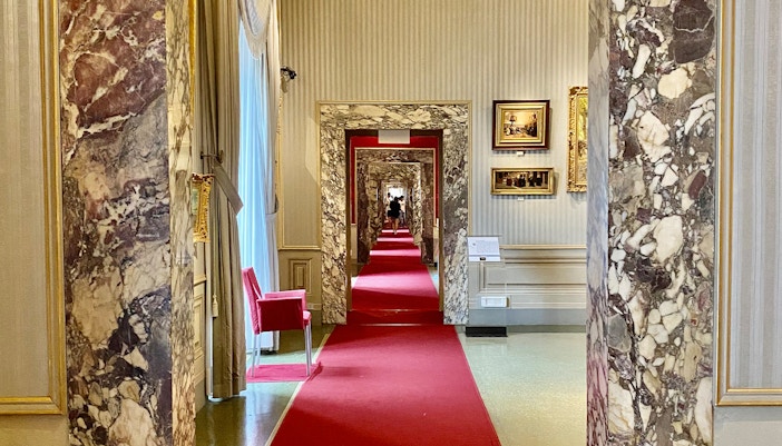 Marble hallway with red carpet at Gallery of Modern Art, Pitti Palace, Florence.