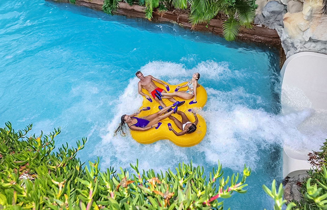 Group enjoying a thrilling vuclano water ride at Siam Park, Tenerife.