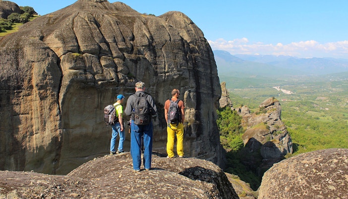 Guests hiking on rocky terrain during Meteora Hiking Tour, Greece.
