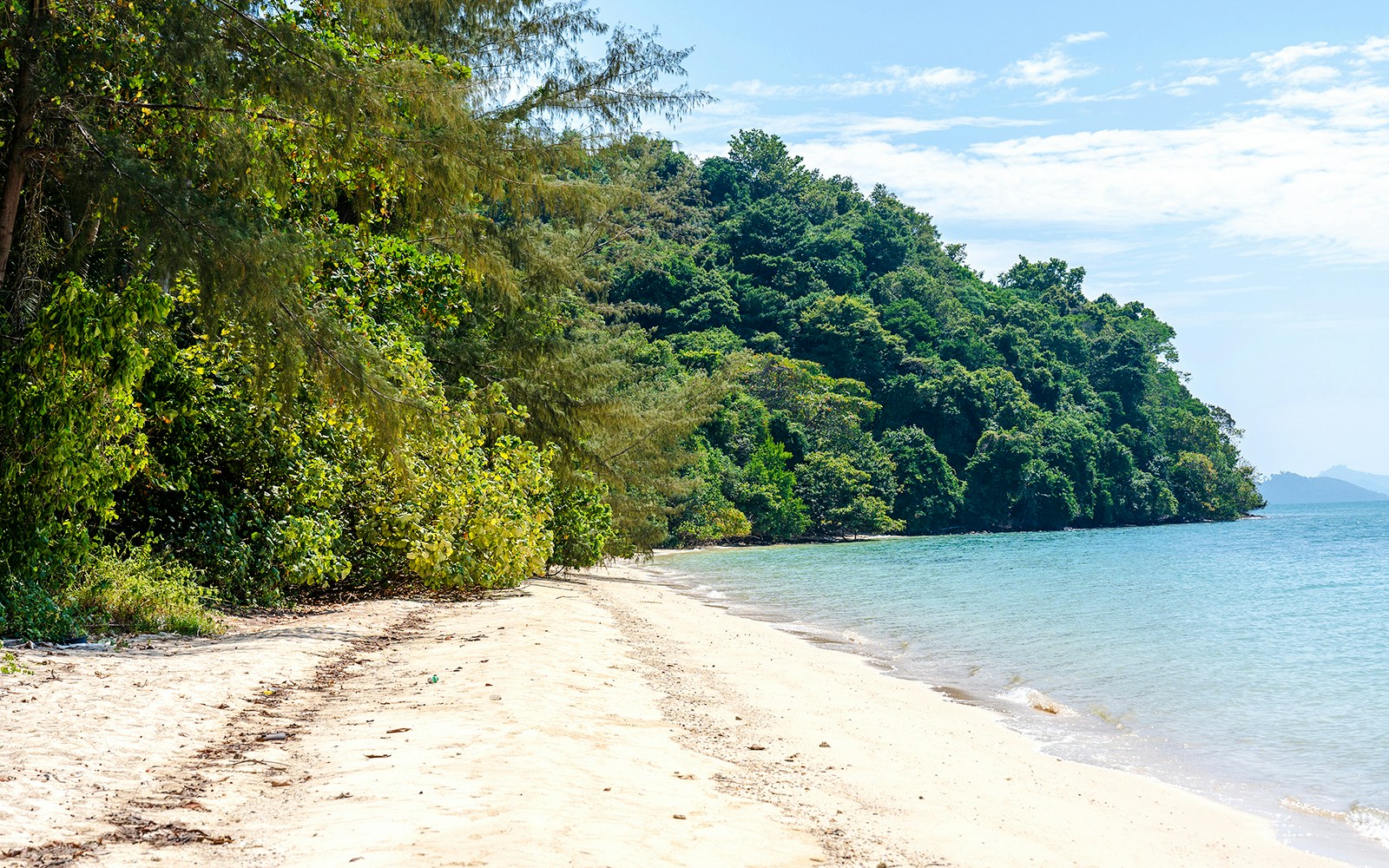 Beach and lush greenery at South Sea pearl farm, Naka Noi, Thailand.