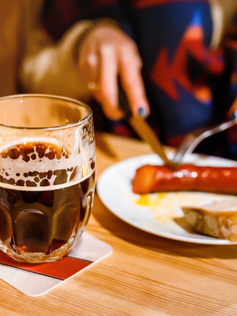 Traditional Czech lunch with beer and sausage in Prague restaurant.
