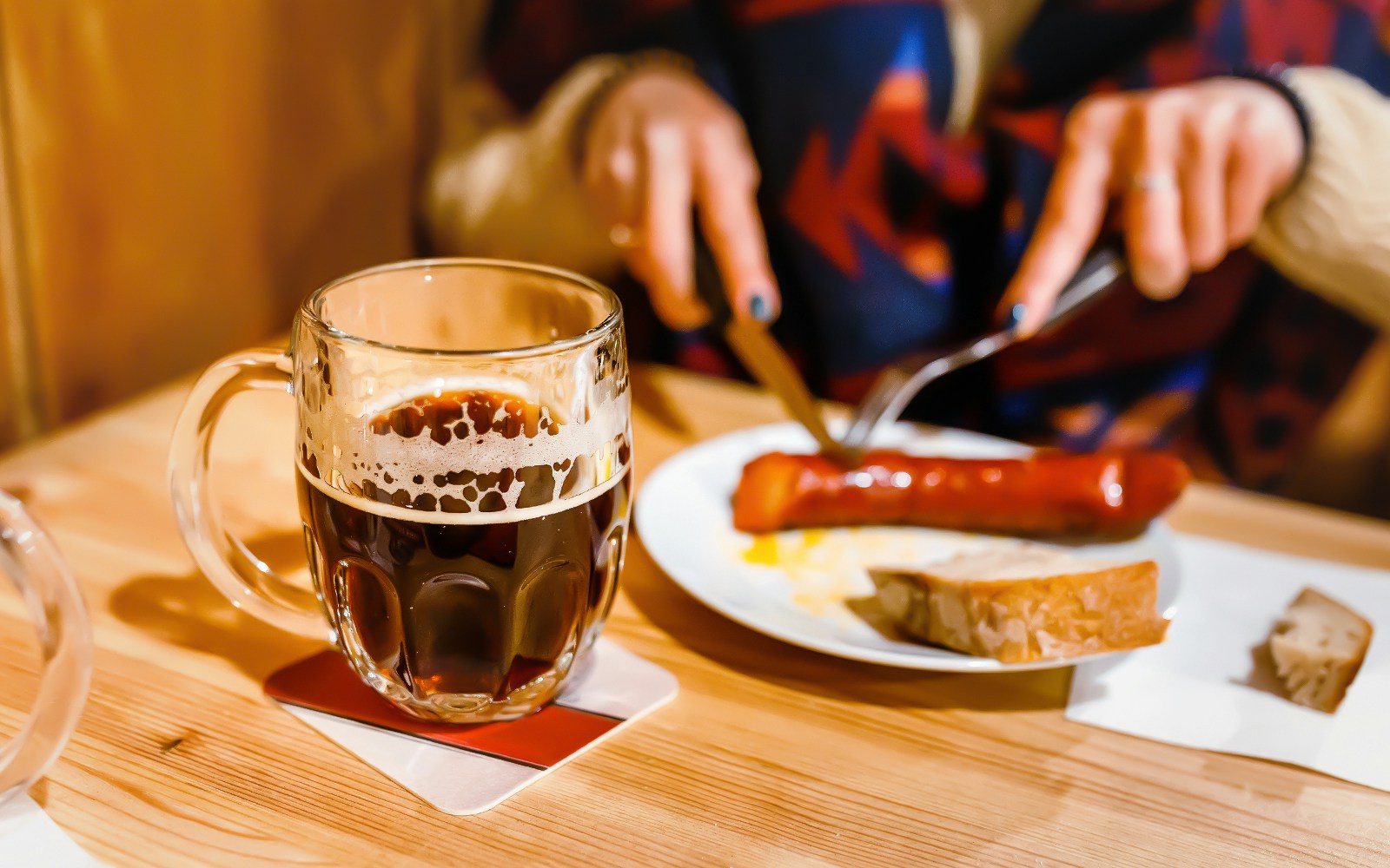 Traditional Czech lunch with beer and sausage in Prague restaurant.