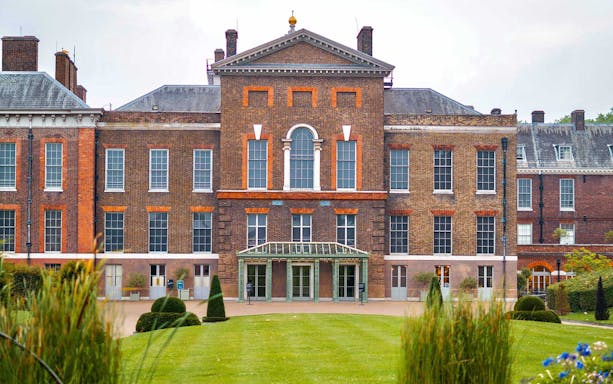 Kensington Palace exterior with brick facade and manicured gardens in London.