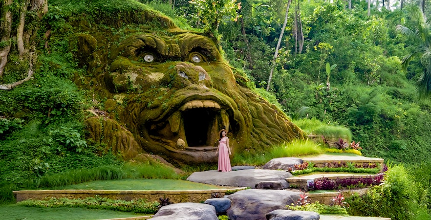 Lady exploring the gorilla cave at Alas Harum, Bali.