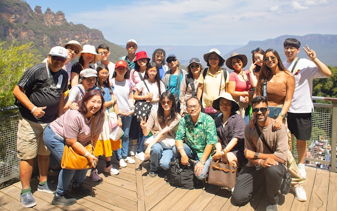 Group of tourists at Blue Mountains lookout during Sydney tour.