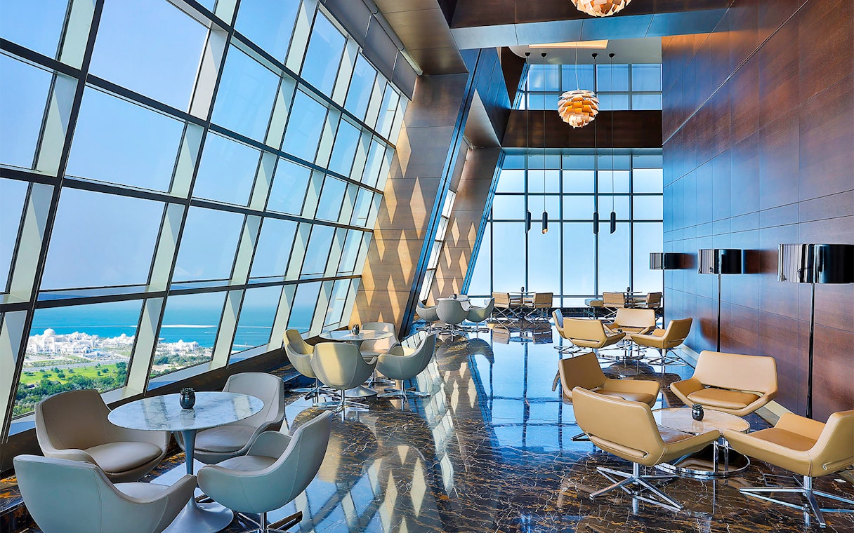 Observation Deck at 300, Etihad Tower, Abu Dhabi with city and sea view through large windows.
