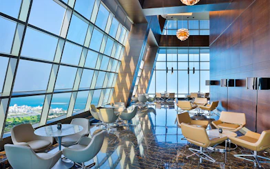 Observation Deck at 300, Etihad Tower, Abu Dhabi with city and sea view through large windows.