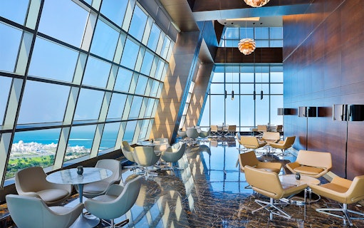 Observation Deck at 300, Etihad Tower, Abu Dhabi with city and sea view through large windows.