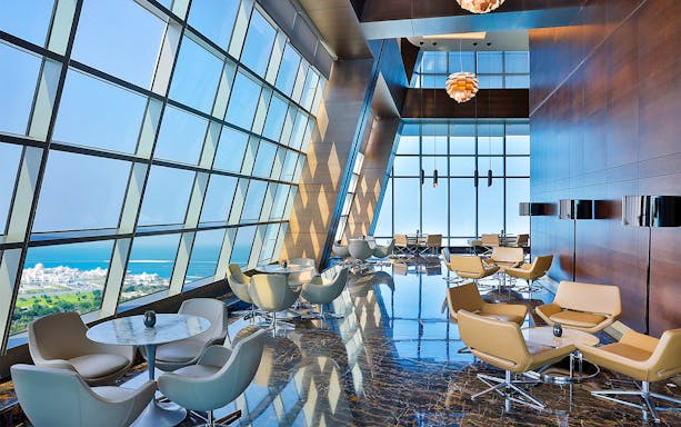 Observation Deck at 300, Etihad Tower, Abu Dhabi with city and sea view through large windows.