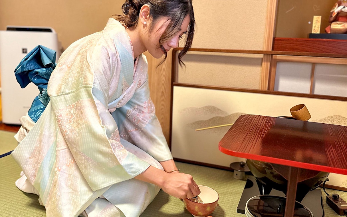 Woman in kimono preparing tea during a ceremony in Shinagawa, Tokyo.