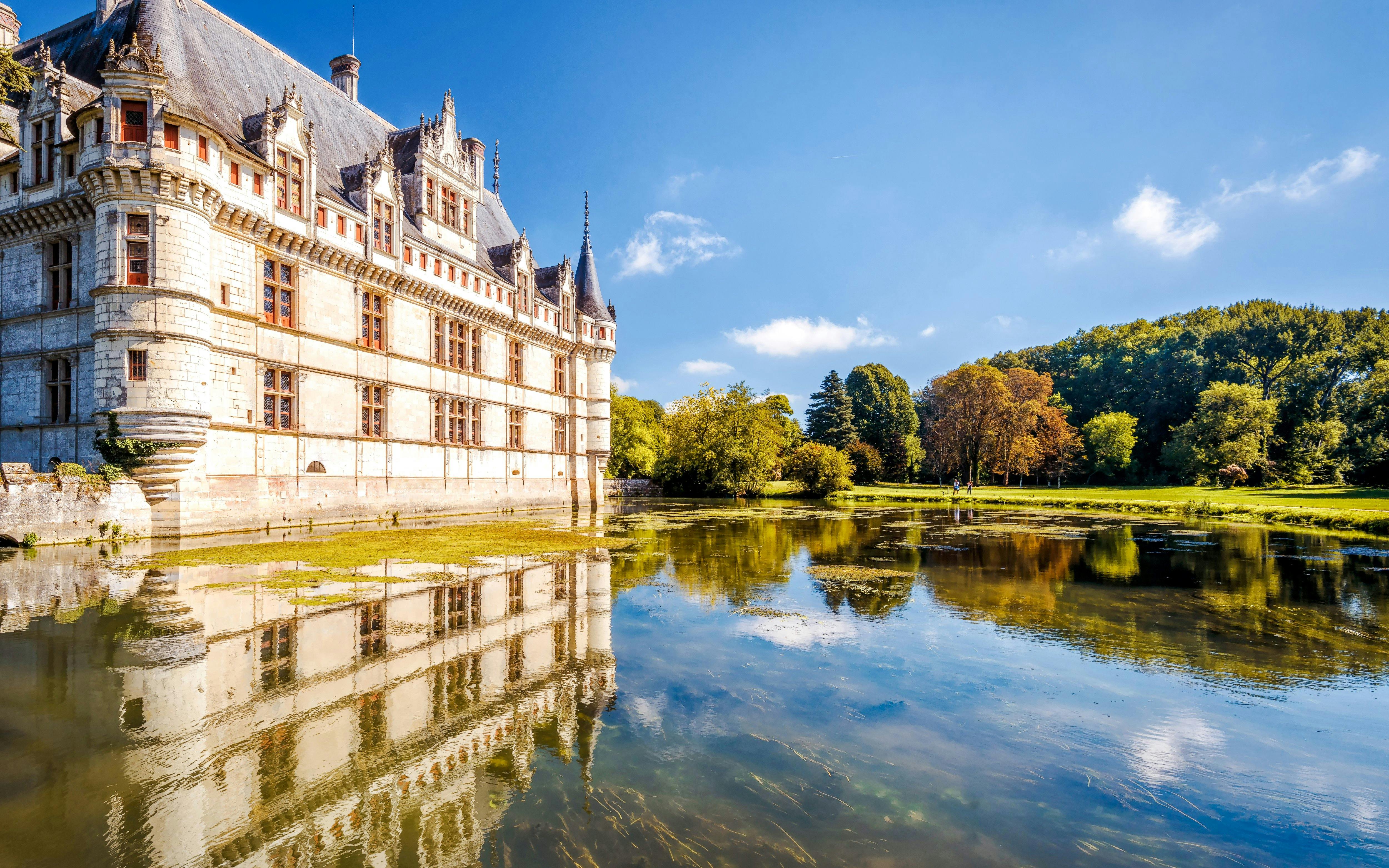 Chateau Azay le Rideau reflected in water, surrounded by trees, Loire Valley, France.