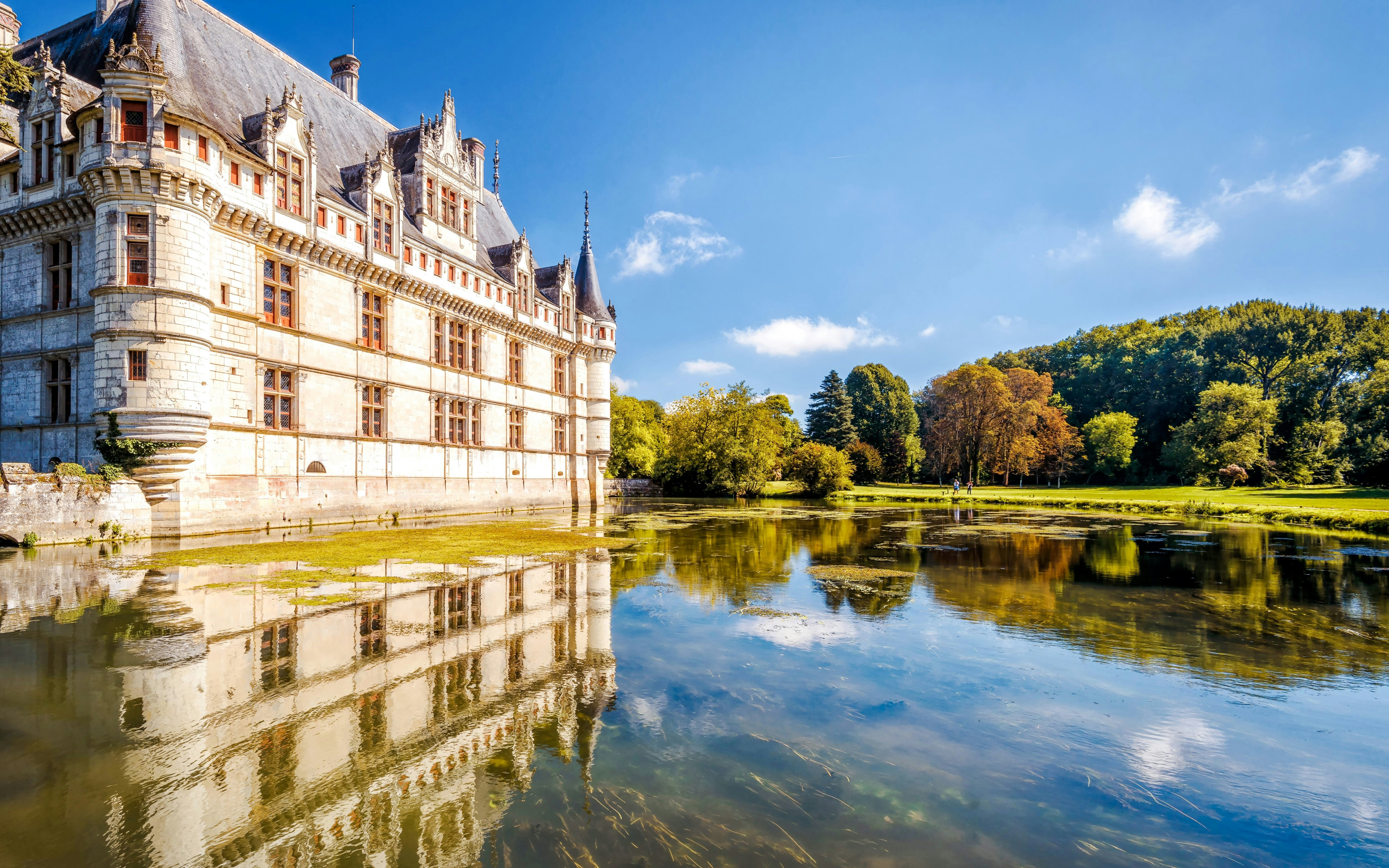 Chateau Azay le Rideau reflected in water, surrounded by trees, Loire Valley, France.