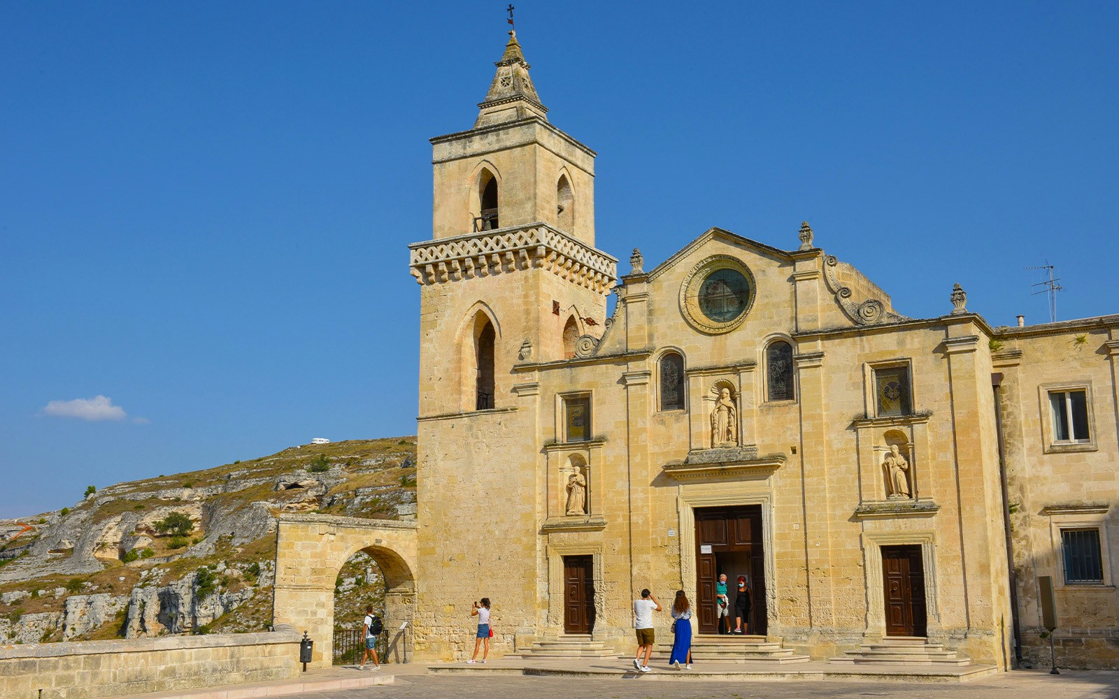Rupestrian Church in Matera with visitors exploring the historic facade.