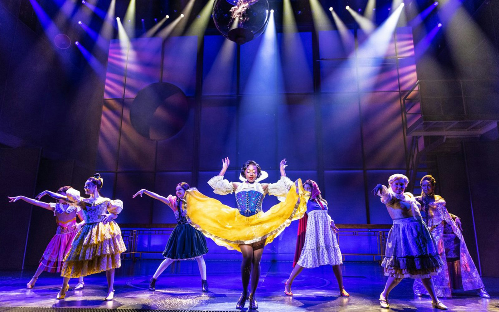 Performers in colorful costumes on stage during "Once Upon a One More Time" show.