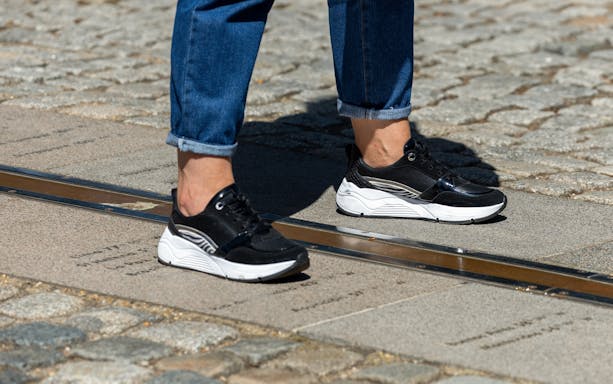 Feet standing on the Meridian line at Greenwich Observatory, London.