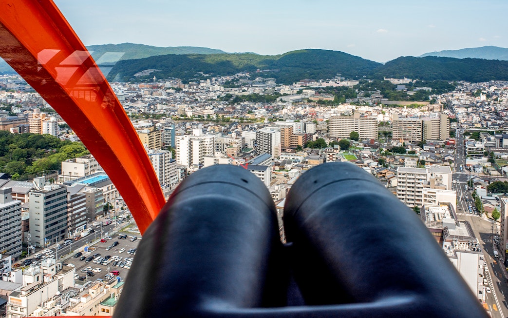 View of Kyoto cityscape from Kyoto Tower observation deck with binoculars.