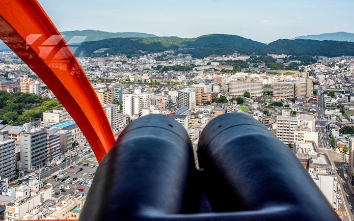 View of Kyoto cityscape from Kyoto Tower observation deck with binoculars.