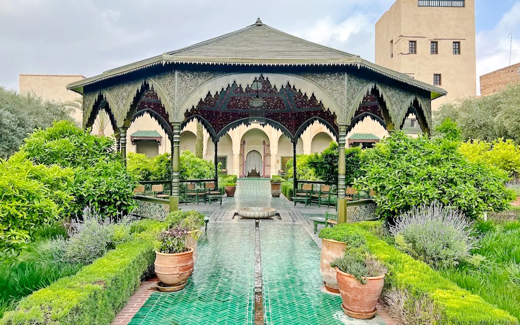 Ornate pavilion and lush gardens at Le Jardin Secret, Marrakech, Morocco.