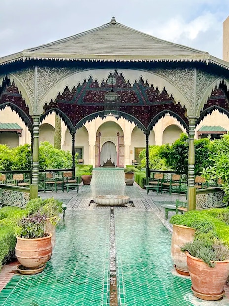 Ornate pavilion and lush gardens at Le Jardin Secret, Marrakech, Morocco.
