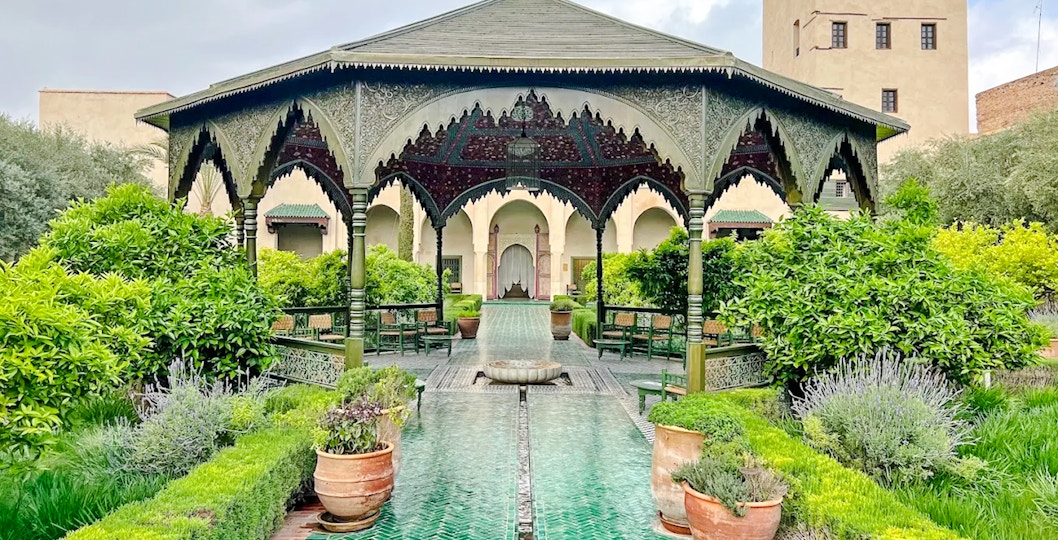 Ornate pavilion and lush gardens at Le Jardin Secret, Marrakech, Morocco.